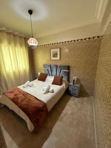 a bedroom with a large bed with towels on it at Piscine, plage et relaxation in Pont Blondin