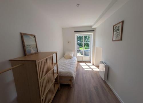 a room with a bedroom with a bed and a window at la clé de la rance in Plouër-sur-Rance