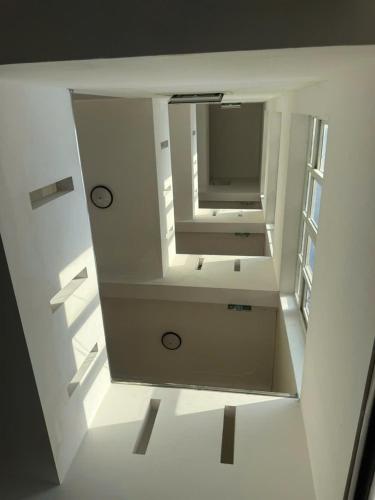 a room with a mirror and a tv on a wall at G7 Hotel in Quyền Hoành
