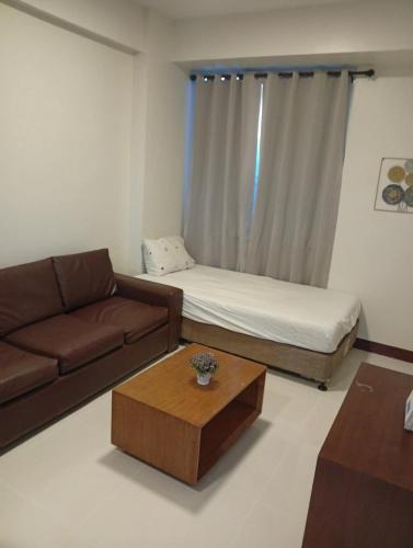 a living room with a couch and a coffee table at Condo in Mactan Newtown in Lapu Lapu City