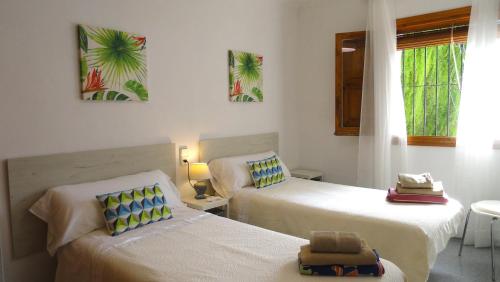 a room with two beds and a window at El Rafalet in Jávea