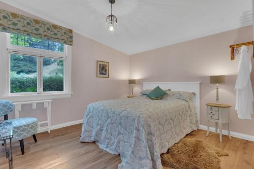 a bedroom with a bed and a desk and a window at Rose Cottage - Tranquil retreat in Tinui