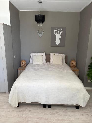 a bedroom with a large bed with a white comforter at B & B it Heech in Ferwerd