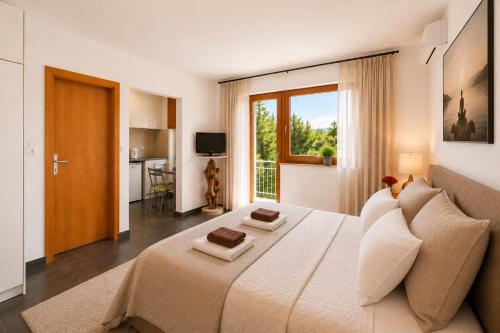 a bedroom with a large bed and a large window at SunSeoce Apartments in Budva
