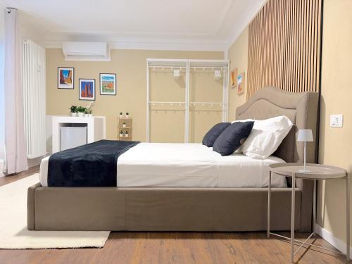 a bedroom with a large bed and a table at Ugo Jacuzzi Apartment in Bologna