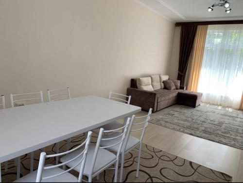 a living room with a table and chairs and a couch at Дом у Айбека in Tamga