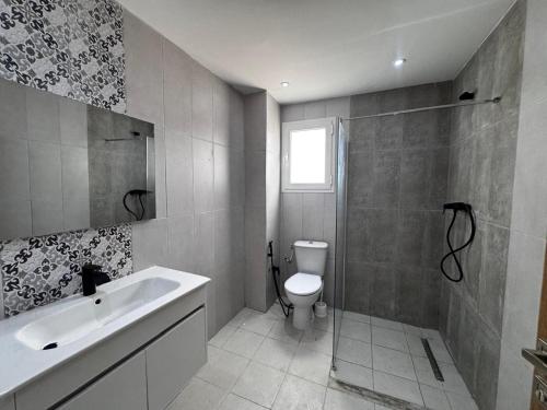a bathroom with a toilet and a sink and a shower at Horizon yasmine in Yasmine