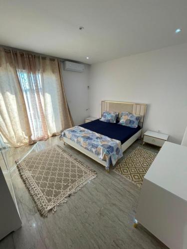 a bedroom with a bed in a room with curtains at Horizon yasmine in Yasmine