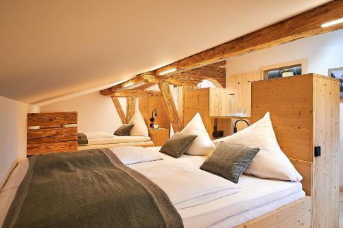 a bedroom with two beds with white sheets and pillows at Forsthaus Valepp in Schliersee