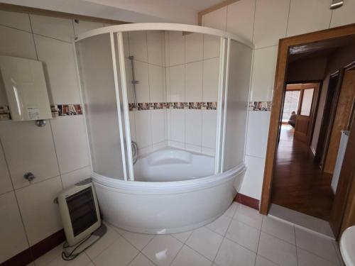 a bathroom with a tub with a tv in it at Apartment Emir in Mostar