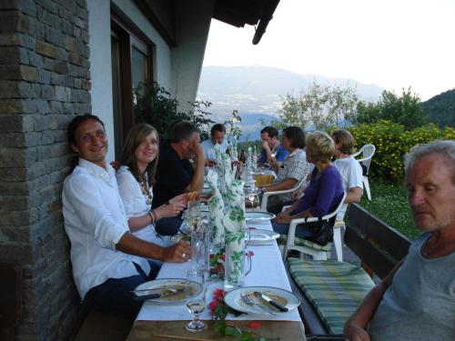 a group of people sitting at a long table at Ferienwohnung Gästehaus Inge in Zlan