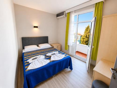 a hotel room with a bed with towels on it at Anadolu Hotel in Istanbul