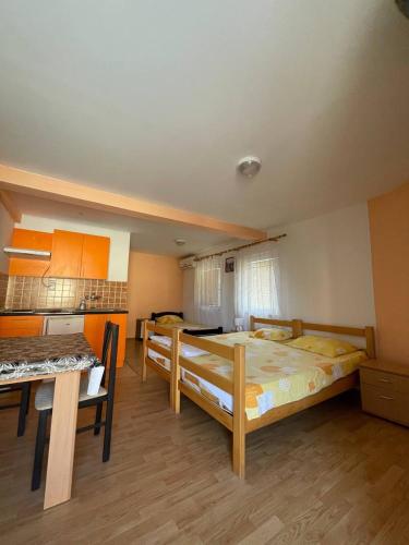 a room with two bunk beds and a kitchen at Deskom Žuta Vila in Veliko Gradište
