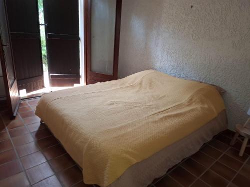 a bed sitting in a room with a window at Beach house within walking distance in La Teste-de-Buch