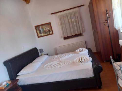 a bedroom with a bed with a black bed frame at Kastri in Kythira