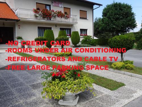 a sign that reads no credit card rooms under air conditioning refrigerators and cable tv at Rooms Kapelj in Postojna