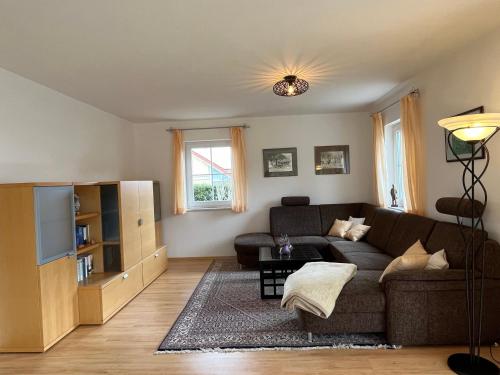 a living room with a couch and a tv at Haus Ammertal in Peißenberg