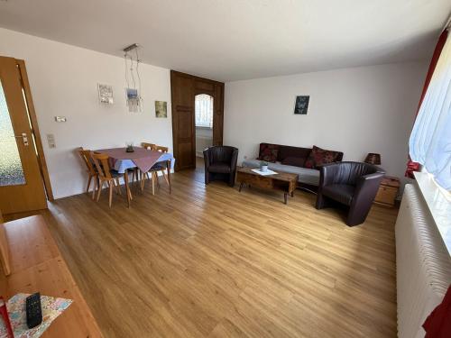 a living room with a couch and a table at Ferienpark Wehrda in Haunetal