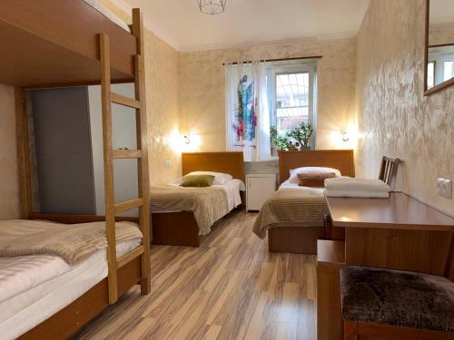 a bedroom with two bunk beds and a desk at Aregak B&B and Tours in Goris