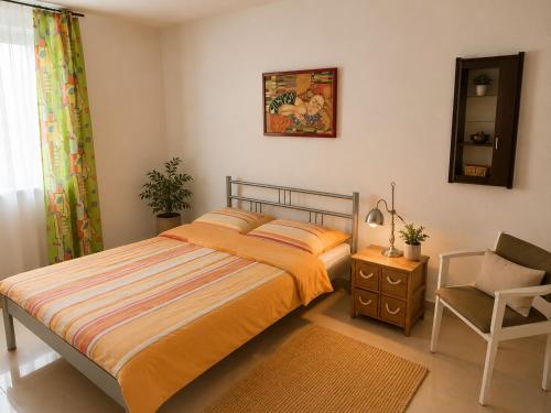 a bedroom with a bed and a chair and a mirror at Apartament4you - Szczycionek in Korpele