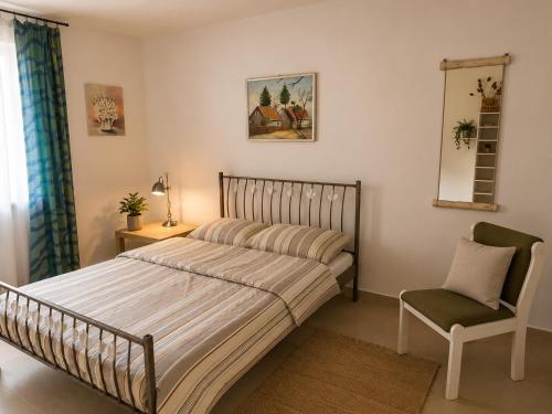 a bedroom with a bed and a chair and a mirror at Apartament4you - Szczycionek in Korpele