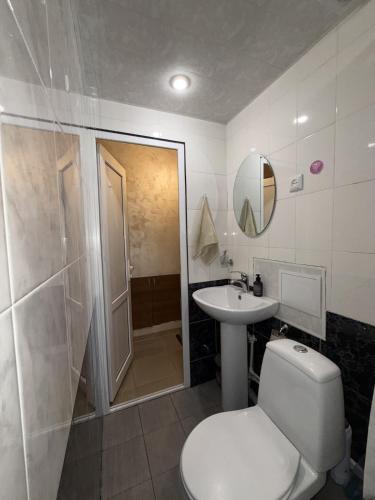 a bathroom with a toilet and a sink and a shower at Aregak B&B and Tours in Goris