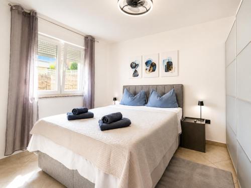 a bedroom with a bed with two towels on it at K&D in Rijeka