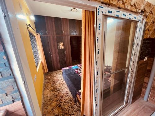 a room with a glass door in a room at Kejriwals Vaikunth 35A in Bangalore