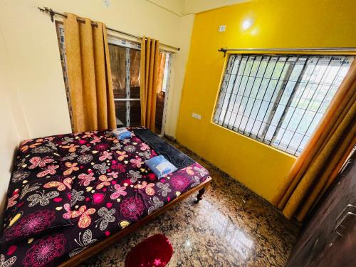 a bedroom with a bed and a window at Kejriwals Vaikunth 35A in Bangalore