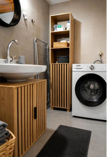 a bathroom with a washing machine and a sink at Pefanis House in Preveza