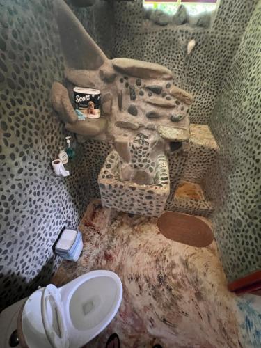 a dirty bathroom with a sink and a toilet at Dolphin Quest Apartment #1 in Pavones