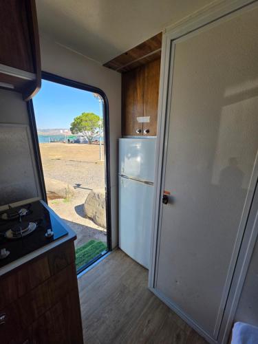 an open door to a kitchen with a refrigerator at רויאל וואן in Tiberias