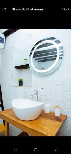 a bathroom with a white sink and a mirror at The courtyard Zanzibar in Ngambo