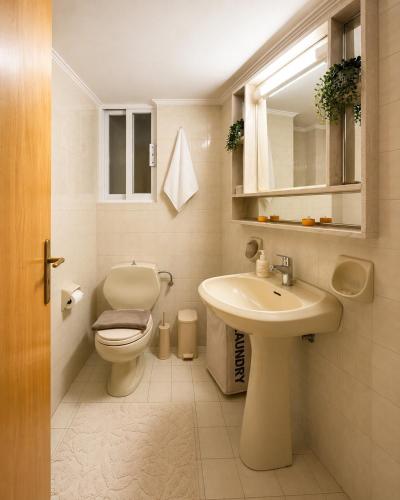 a bathroom with a toilet and a sink at Linda's Apartment in Ialysos