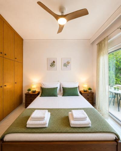 a bedroom with a bed and a ceiling fan at Linda's Apartment in Ialysos