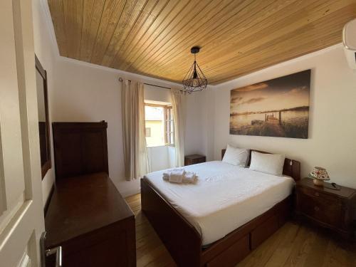 a small bedroom with a bed and a window at Casa das Marias by Gerês Casas in Geres