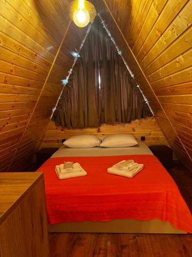 a bedroom with a bed in a tree house at Sweet Cottage in Kobuleti