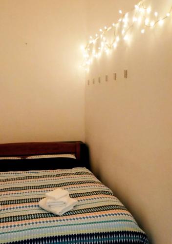 a room with a bed with a towel on it at Cosy Open Space Apartment Bari in Bari