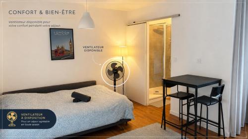 a bedroom with a bed and a table and a lamp at Les Studios de Clément in Poitiers