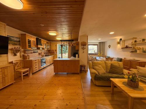 a large living room with a couch and a kitchen at Zejmarka in Mlynky
