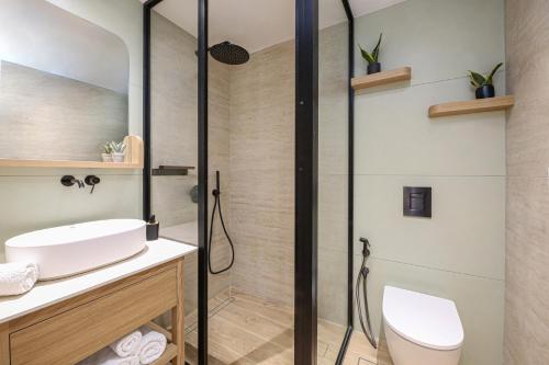a bathroom with a shower and a white sink at Villa Emanouill Nopigia in Kissamos