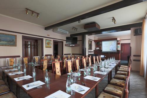 a conference room with a long table and chairs at Hotel Victoria in Plzeň