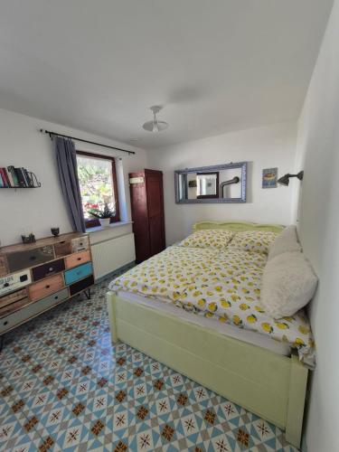 a bedroom with a bed and a dresser and a window at Ferienappartement Tal der Liebe in Sauerthal