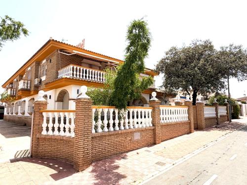 a brick fence in front of a house at Hotel Victoria Matalascañas in Matalascañas
