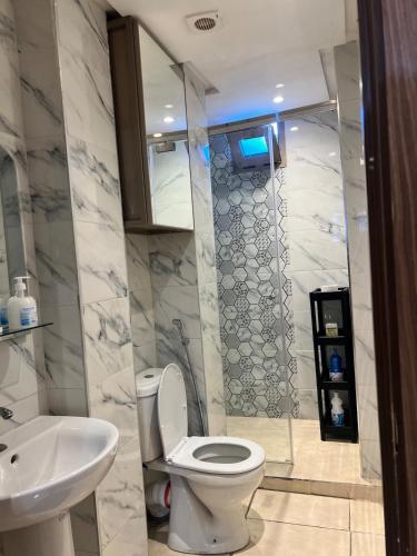 a bathroom with a toilet and a sink at Modern Studio in Kenitra