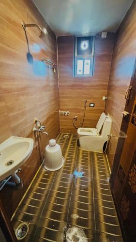 a bathroom with a sink and a toilet at Hotel Royal Nest Inn in Coimbatore