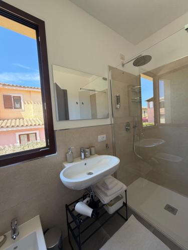 a bathroom with a sink and a shower at Elyas Guest House in Villasimius