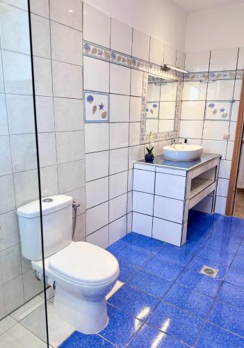 a bathroom with a toilet and a sink at Parea House in Limenaria