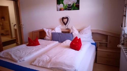 a bedroom with two beds with red pillows at Fewo-Mirnig in Hochrindl