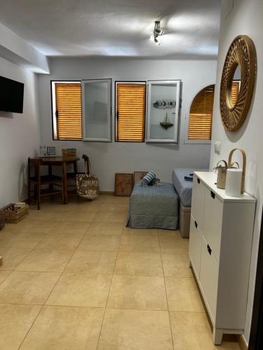 a living room with a bed and a table at Bella Javea in Jávea
